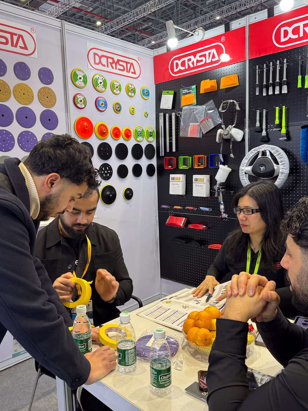 The DCRYSTA team interacting with customers at their booth during Automechanika Shanghai 2025.
